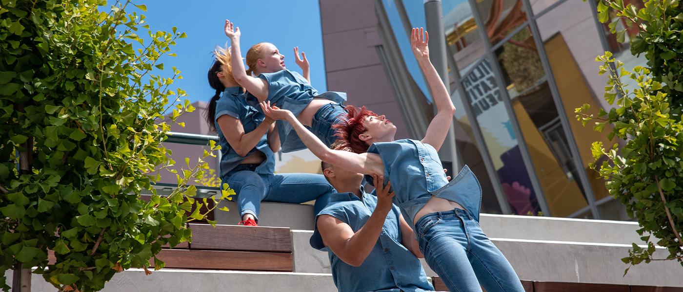 2 duets of dancers outdoors and in blue and red shoes, 2 dancers lifted by the other 2 dancers.