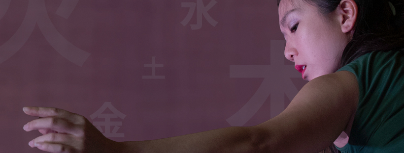 One dancer with arm extended on purple background with Chinese characters